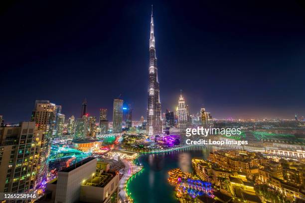 The Burj Khalifa soars 829 meters into the clear Arabian sky and towers over the luxuriant oasis of Dubai.