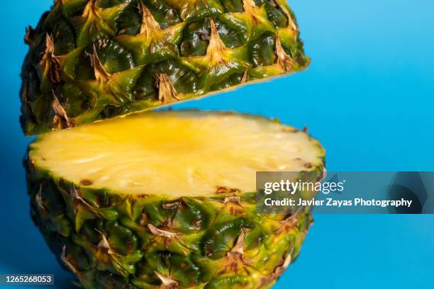 pineapple on blue colored background - pineapple halved stock pictures, royalty-free photos & images