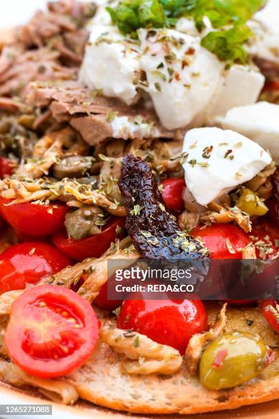 Traditional Pane Cunzato, with: bread, tomatoes, eggplant, capers, tuna, mozzarella, oregano, Alfredo's bars, Salina island, Aeolian Islands, Sicily,...