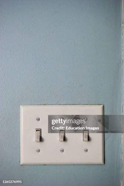 Three Light Switches on Wall.