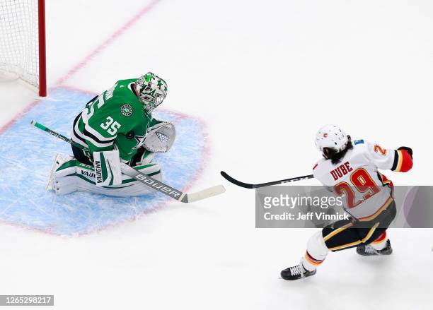 Anton Khudobin of the Dallas Stars makes the first period chest save on Dillon Dube of the Calgary Flames in Game One of the Western Conference First...