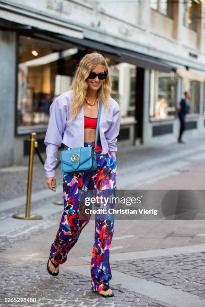 Emili Sindlev is seen wearing cropped jacket and top, Louis Vuitton bag, pants with floral print outside Lovechild 1979 during Copenhagen Fashion...