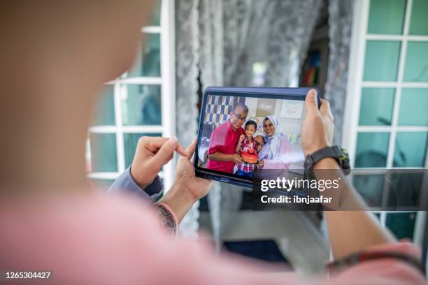 family video calling using devices - lock down malaysia stock pictures, royalty-free photos & images