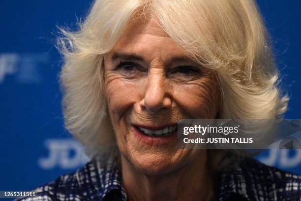 Britain's Queen Camilla reacts during a reception following her visit of a laboratory that specialises in developing new approaches to study multiple...