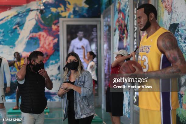Visitors take photos with Lebron James wax figure at the Museo de Cera on August 11, 2020 in Mexico City, Mexico. Despite Mexico City government...