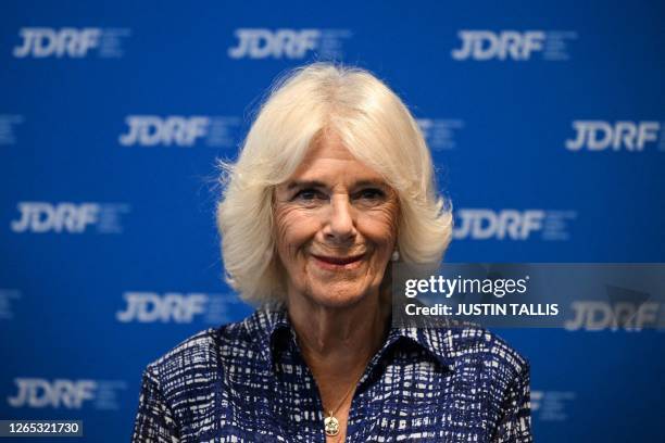 Britain's Queen Camilla reacts during a reception following her visit of a laboratory that specialises in developing new approaches to study multiple...