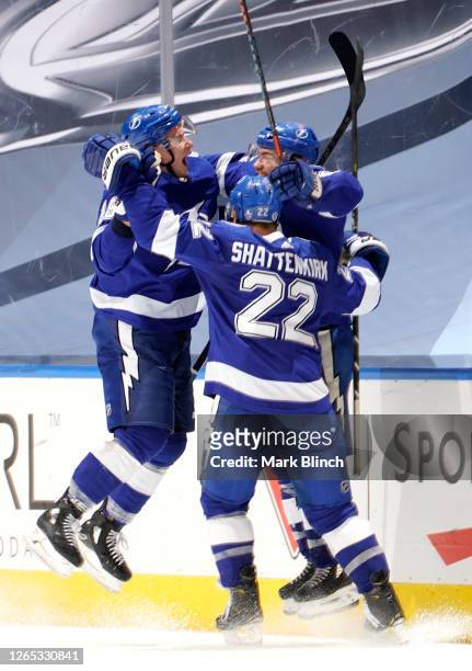 Brayden Point of the Tampa Bay Lightning celebrates his game winning goal at 10:27 in the fifth overtime with teammates Ondrej Palat and Kevin...