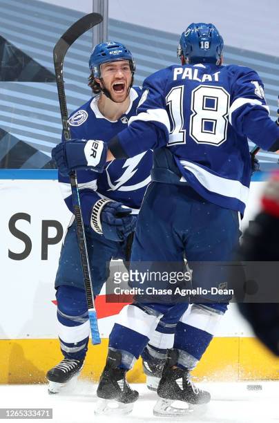 Brayden Point of the Tampa Bay Lightning celebrates his game winning goal at 10:27 in the fifth overtime with teammate Ondrej Palat during Game One...