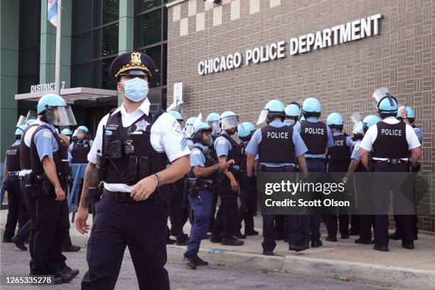 Chicago police stand guard as demonstrators protest outside the department's 7th District station on August 11, 2020 in Chicago, Illinois. The...