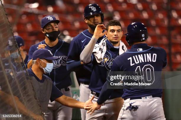 Mike Zunino of the Tampa Bay Rays celebrates with Willy Adames after scoring a run against the Boston Red Sox during the seventh inning at Fenway...