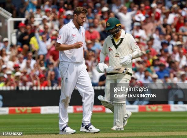 England's Ollie Robinson reacts after taking the wicket of Australia's Nathan Lyon on day two of the second Ashes cricket Test match between England...