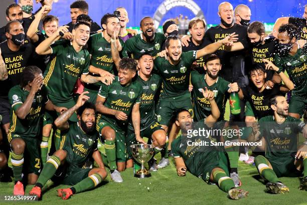 Players of Portland Timbers celebrate with the champions trophy after defeating Orlando City 2-1 in the final match of MLS Is Back Tournament at ESPN...