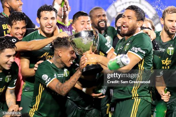 Andy Polo and Bill Tuiloma of Portland Timbers celebrate with the MLS Is Back champions trophy after the final match of MLS Is Back Tournament...