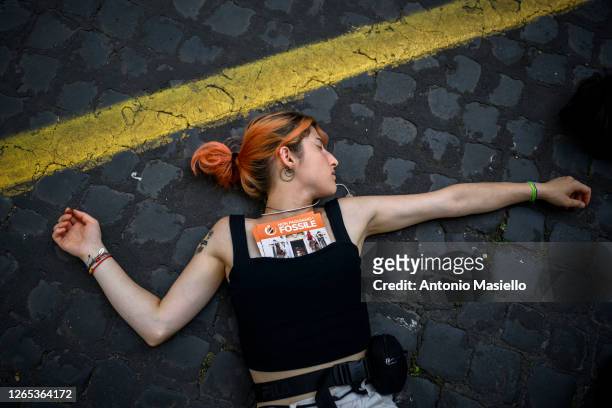 Climate activists from Ultima Generazione lay down on the ground during a climate crisis protest at Via della Conciliazione, on June 29, 2023 in...