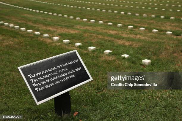 Small numbered grave markers for unknown soldiers who died in the Battle of Gettysburg line the lawn inside the Soldiers' National Cemetery, across...