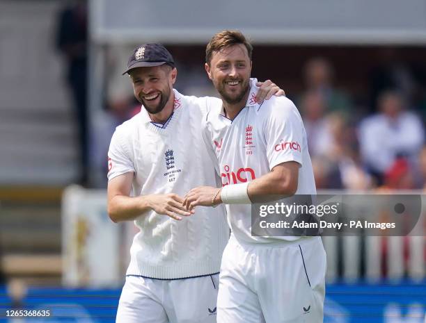 England's Chris Woakes and Ollie Robinson celebrate the wicket of Australia's Nathan Lyon during day two of the second Ashes test match at Lord's,...