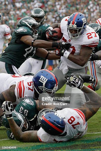 Running back Brandon Jacobs of the New York Giants breaks the tackle of defender Jarrad Page of the Philadelphia Eagles for a two point conversion...