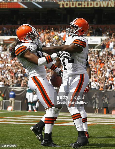 Wide receiver Joshua Cribbs of the Cleveland Browns celebrates after scoring a touchdown with tight end Benjamin Watson against the Miami Dolphins at...