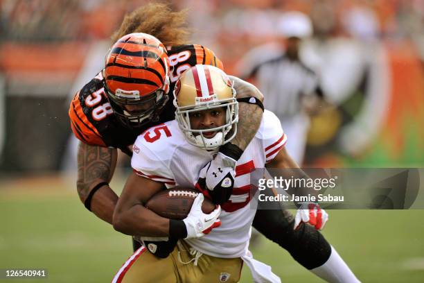 Rey Maualuga of the Cincinnati Bengals tackles Michael Crabtree of the San Francisco 49ers after Crabtree made a pass reception at Paul Brown Stadium...