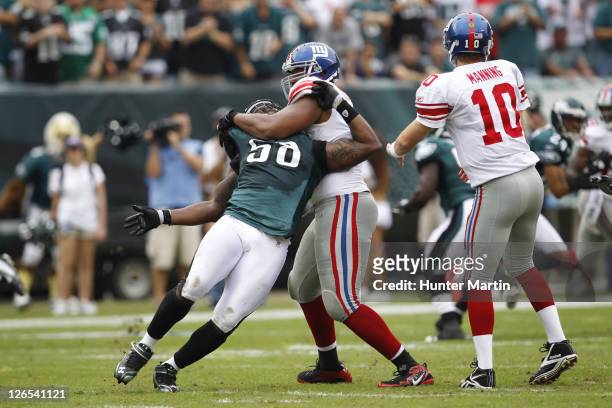 Defensive end Trent Cole of the Philadelphia Eagles is blocked by offensive tackle Will Beatty of the New York Giants during a game on September 25,...