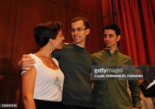 Shane Bauer and Josh Fattal , two US hikers held by Iran for more than two years on spying charges, hug with fellow former detainee Sarah Shroud...