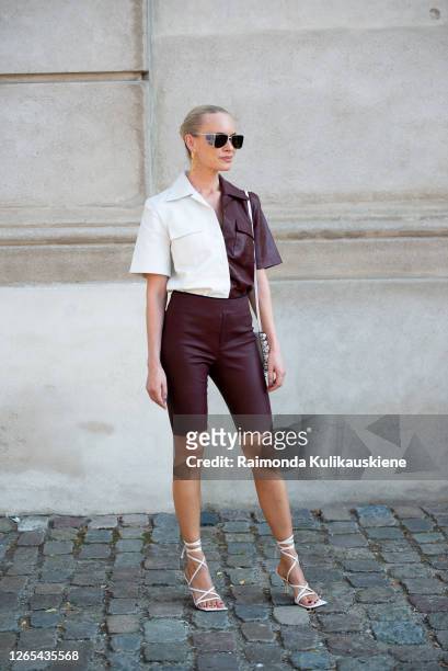 Thora Valdimars outside Remain Birger Christensen wearing brown leather shorts and leather brown and white shirt during Copenhagen fashion week SS21...