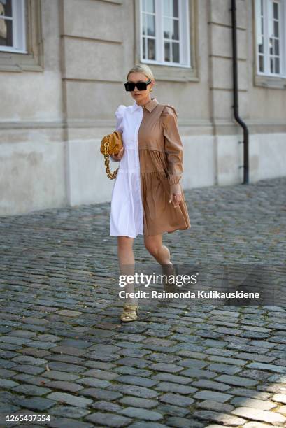 Justina Czerniak outside Remain Birger Christensen wearing half white half beige dress, Bottega Veneta shoes and Bottega Veneta bag during Copenhagen...