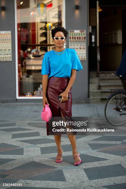 Elizabeth Delphine outside Rains wearing dark red leather skirt, blue t-shirt and pink bag during Copenhagen fashion week SS21 on August 11, 2020 in...