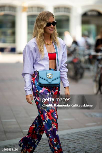 Emili Sindlev outside Lovechild 1979 wearing colorful purple/red/blue pants, red top, light purple jacket and blue Louise Vuitton bag during...