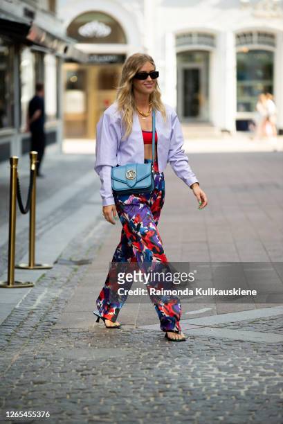 Emili Sindlev outside Lovechild 1979 wearing colorful purple/red/blue pants, red top, light purple jacket and blue Louise Vuitton bag during...
