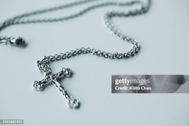 closeup of cross pendant - crucifixion stock pictures, royalty-free photos & images