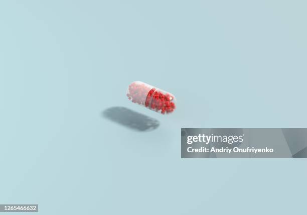 medical capsule filled with coronavirusses - pillenbox stock-fotos und bilder