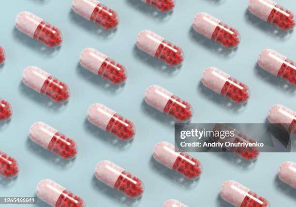 medical capsule filled with coronavirusses - pillenbox stock-fotos und bilder