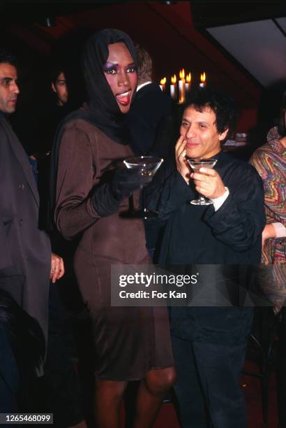 Grace Jones and Azzedine Alaia attend the Azzedine Alaia Dinner Party at Le Palace during Paris Fashion Week in the 1990s in Paris, France.