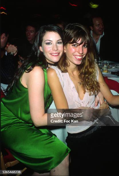 Liv Tyler and Lou Doillon attend the Sidaction Dinner Party at Pavillon D'Armenonville during Paris Fashion Week in the 1990s in Paris, France.