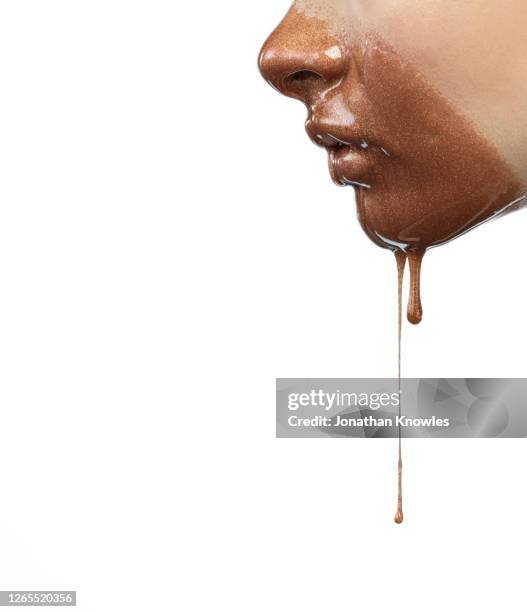 gold makeup dripping from face - bronze stock-fotos und bilder