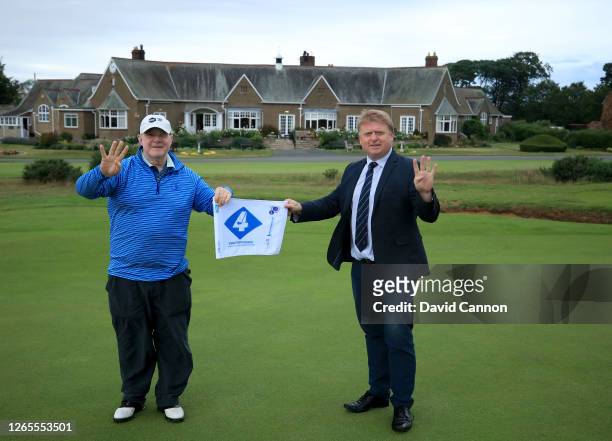 Nick Edmund the founder of GlobalGolf4Cancer poses on the 18th green in front of the clubhouse with Gary Pierce the Manager of Ganton Golf Club with...