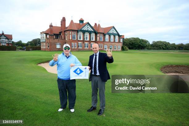 Nick Edmund the founder of GlobalGolf4Cancer poses on the 18th hole with his special pin flag during Nick's story to celebrate Harry Colt's birthday...