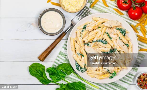 chicken alfredo parmesan pasta with spinach - penne stock pictures, royalty-free photos & images