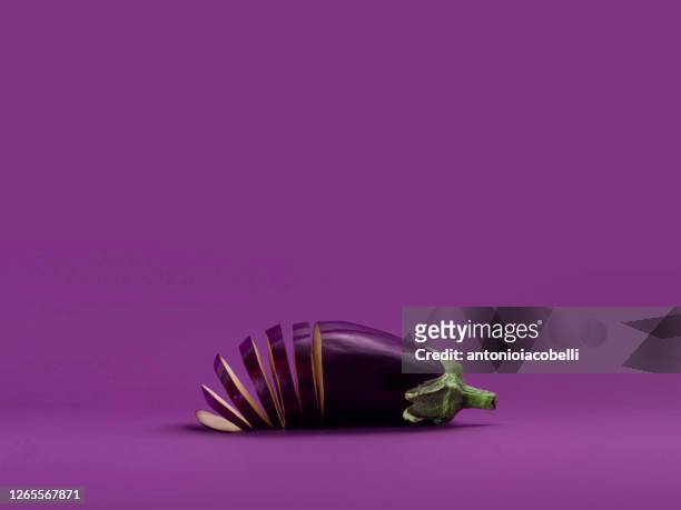 sliced aubergine on a purple background - eggplant imagens e fotografias de stock