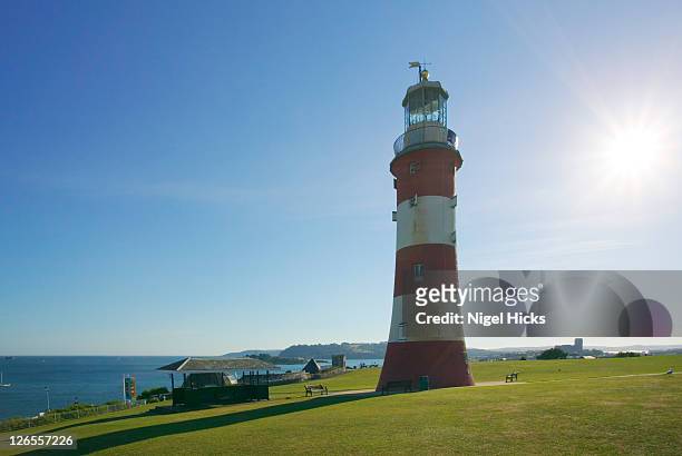 smeaton's tower, now on plymouth hoe, was first built nearly 250 years ago and once stood 14 miles offshore guiding ships away from the treacherous eddystone rocks - plymouth hoe stock pictures, royalty-free photos & images