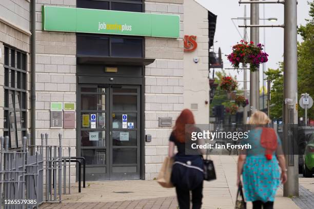 Two women walk past the Job Centre building on August 12, 2020 in Middlesbrough, United Kingdom. The Office For National Statistics reported the UK's...