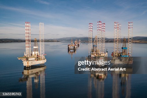Oil Rig Reflection Low Angle Drone Shot Showing The Reflections Of Various Oil Drilling ...