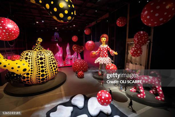 People admire the artworks in an exhibition by Japanese artist Yayoi Kusama entitled 'You, Me and the Balloons' in the Aviva Studios gallery in...