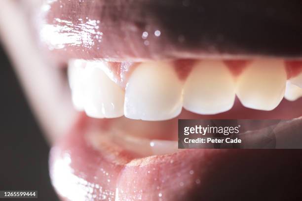 close up of female mouth showing teeth - word of mouth stock pictures, royalty-free photos & images