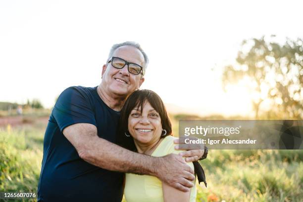 portrait of a smiling senior couple on the farm - 60 64 years stock pictures, royalty-free photos & images
