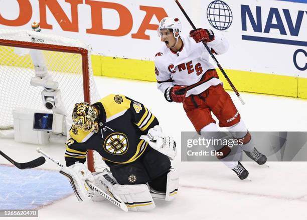 Sebastian Aho of the Carolina Hurricanes celebrates a first period goal by Joel Edmundson against Tuukka Rask of the Boston Bruins in Game One of the...