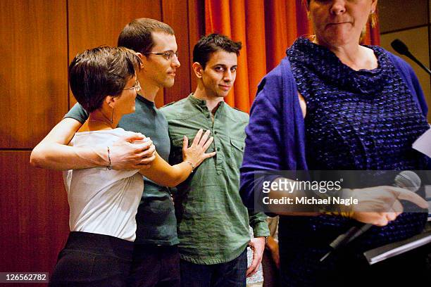 Sarah Shourd embraces Shane Bauer and Josh Fattal , two American hikers released after spending more than two years imprisoned in Iran, after a press...