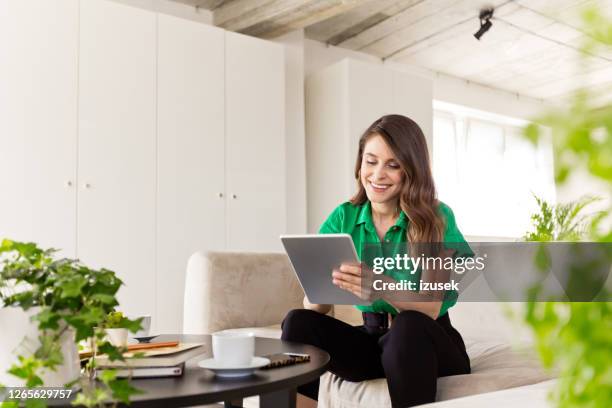 beautiful woman working in the eco-friendly green office - green sofa stock pictures, royalty-free photos & images