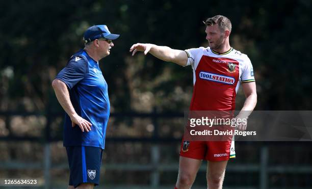 Chris Boyd, the Northampton Saints director of rugby talks to Dan Biggar during the Northampton Saints training session held at Franklin's Gardens on...